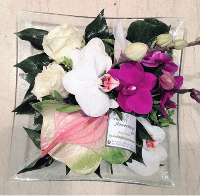 Exclusive season flowers in glass tray arrangement