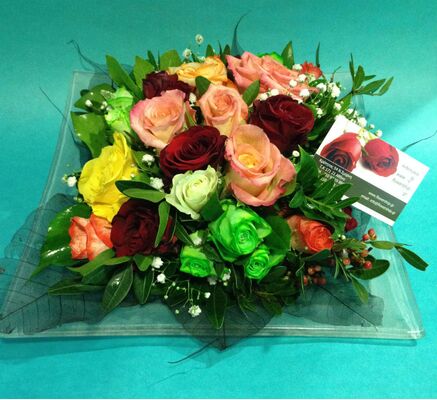 Flower arrangement on tray. Multi color roses combination