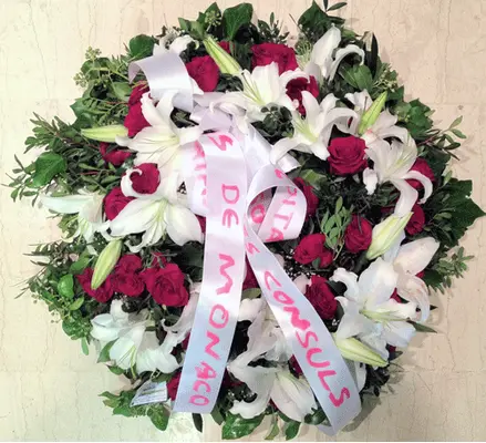 White & red condolences wreath.