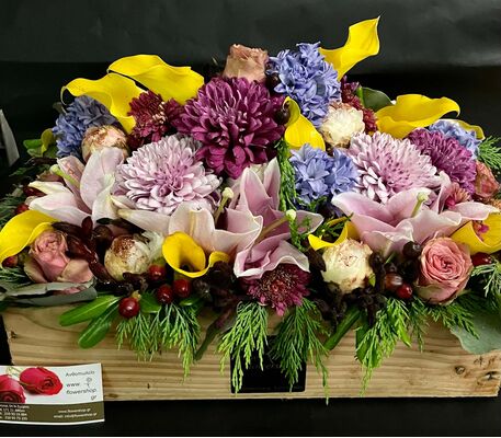 Flower Arrangement in wooden crane or basket.