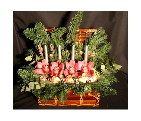 Christmas arrangement in basket with candles