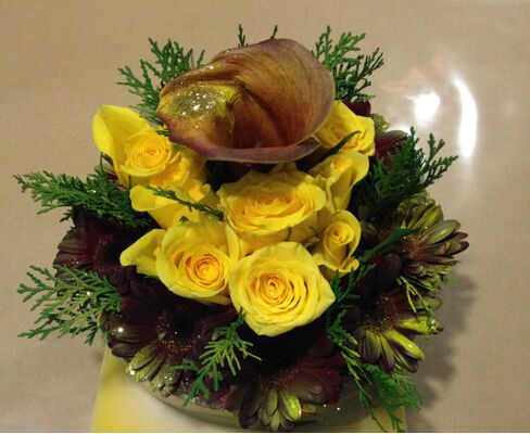 Flower arrangement in glass tray with autumn flavor