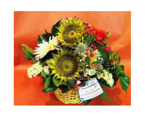 Season flowers arrangement in small basket with sunflowers