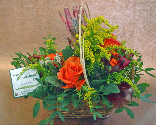 Season flowers arrangement in small basket