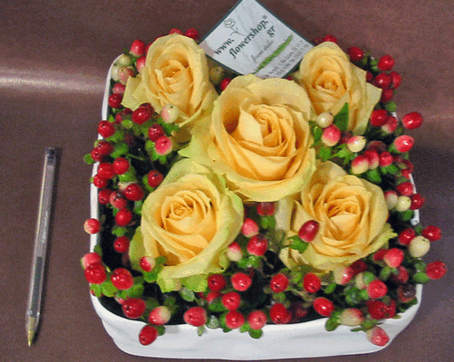 Flower arrangement in small ceramic "paper look" pot  with autumn flavor