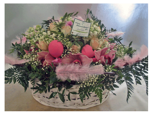 Easter flower arrangement in basket with accessories
