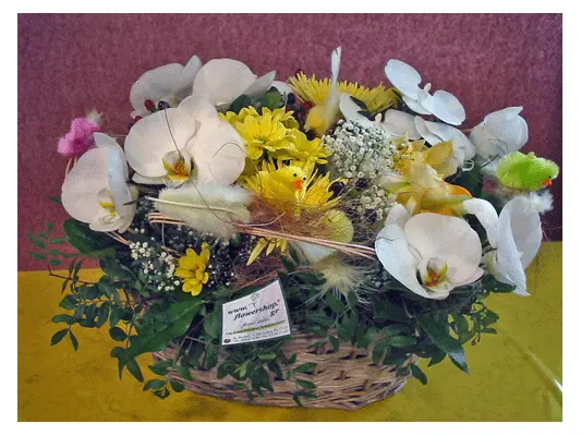Flower arrangement in basket with Easter accessories