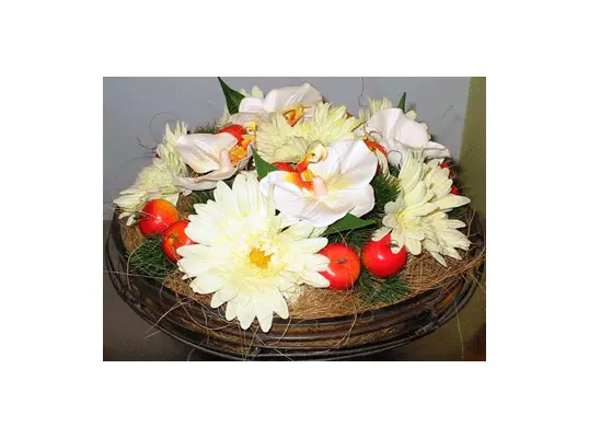 Artificial flower arrangement in vintage iron + glass pot