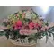 Easter flower arrangement in basket with accessories