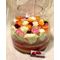 Arrangement of multi colored roses  in vase with decorative colored sand layers!!!