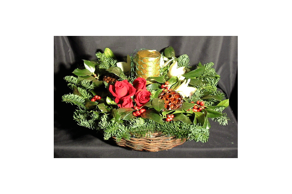 Christmas arrangement in basket with candle
